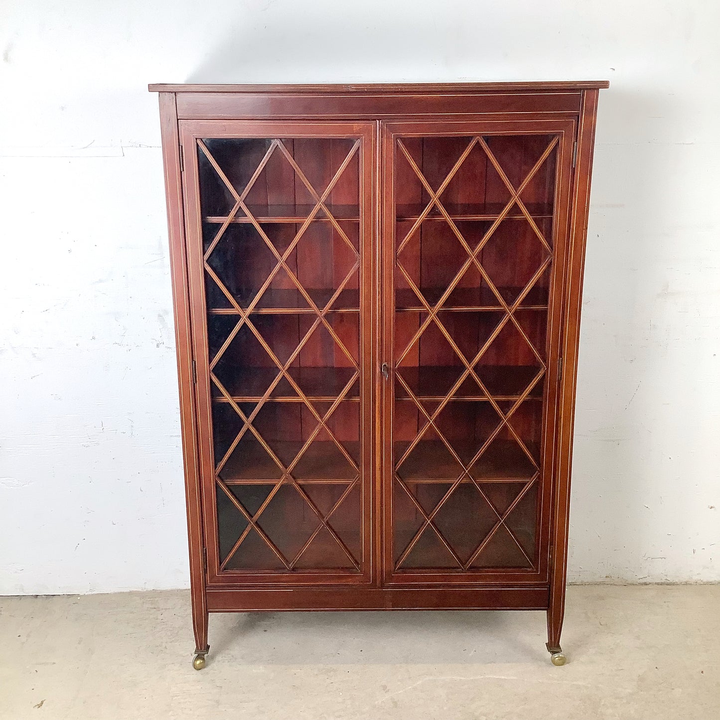 Edwardian Revival Mahogany Diamond Lattice Glazed Bookcase | Satinwood Inlay | Brass Casters