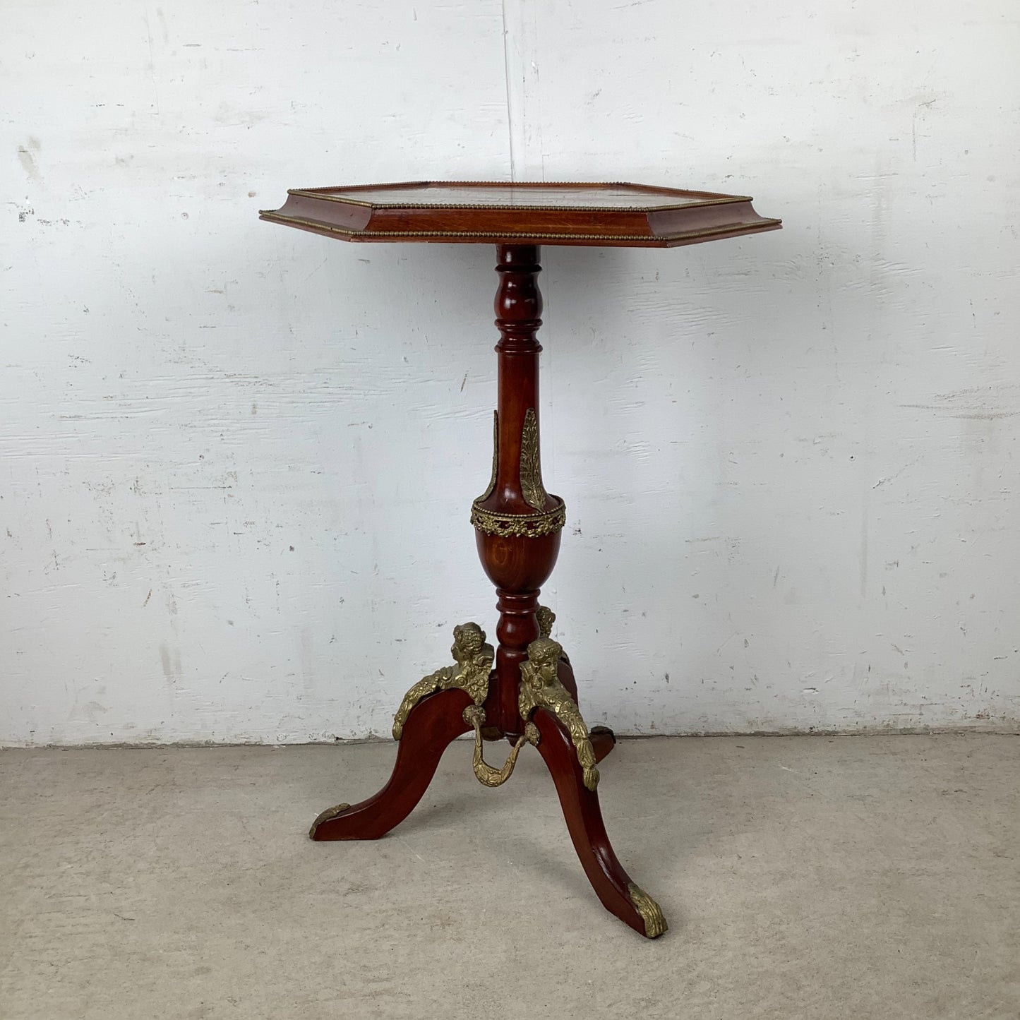 Ornate Pedestal Display Table with Brass Figural Accents
