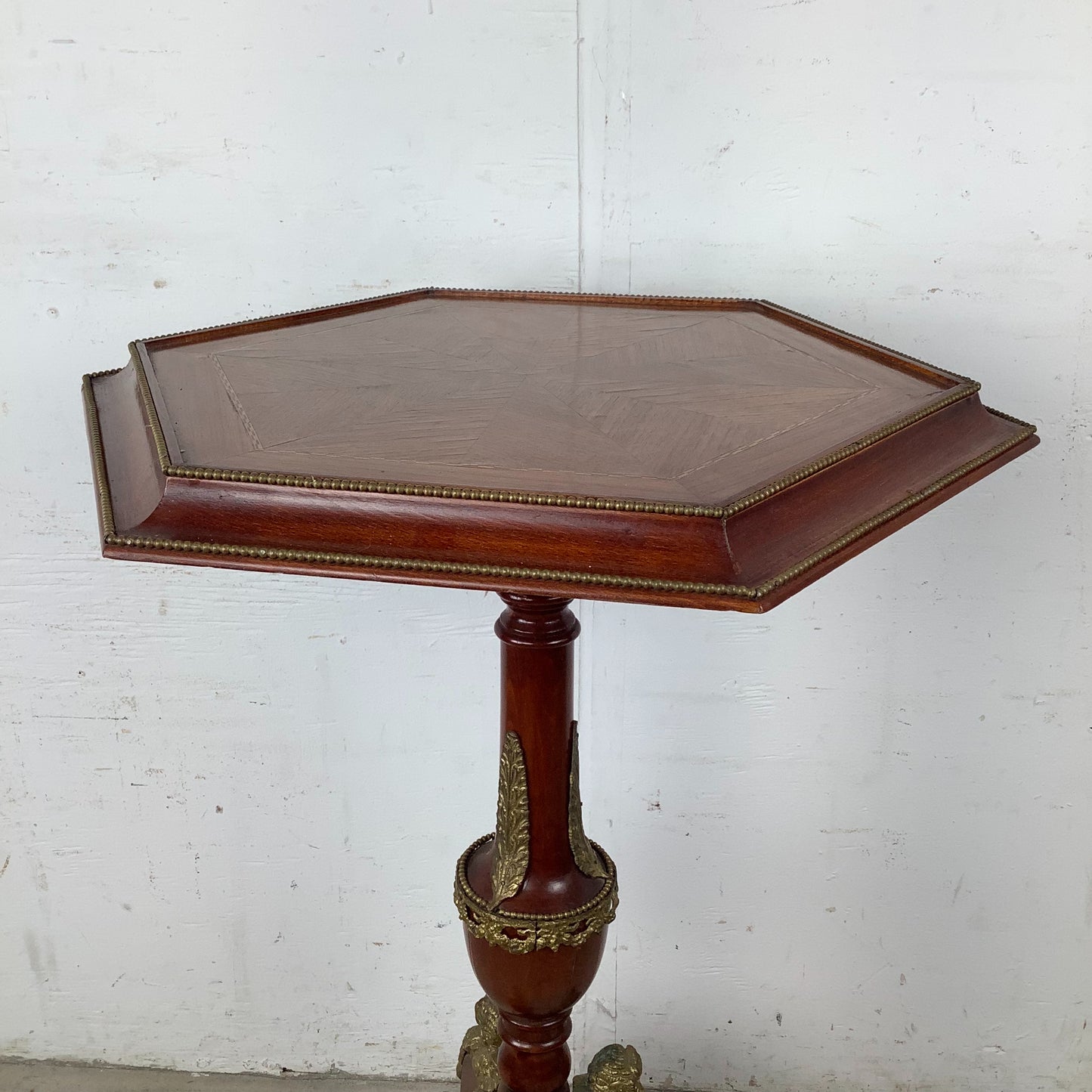 Ornate Pedestal Display Table with Brass Figural Accents