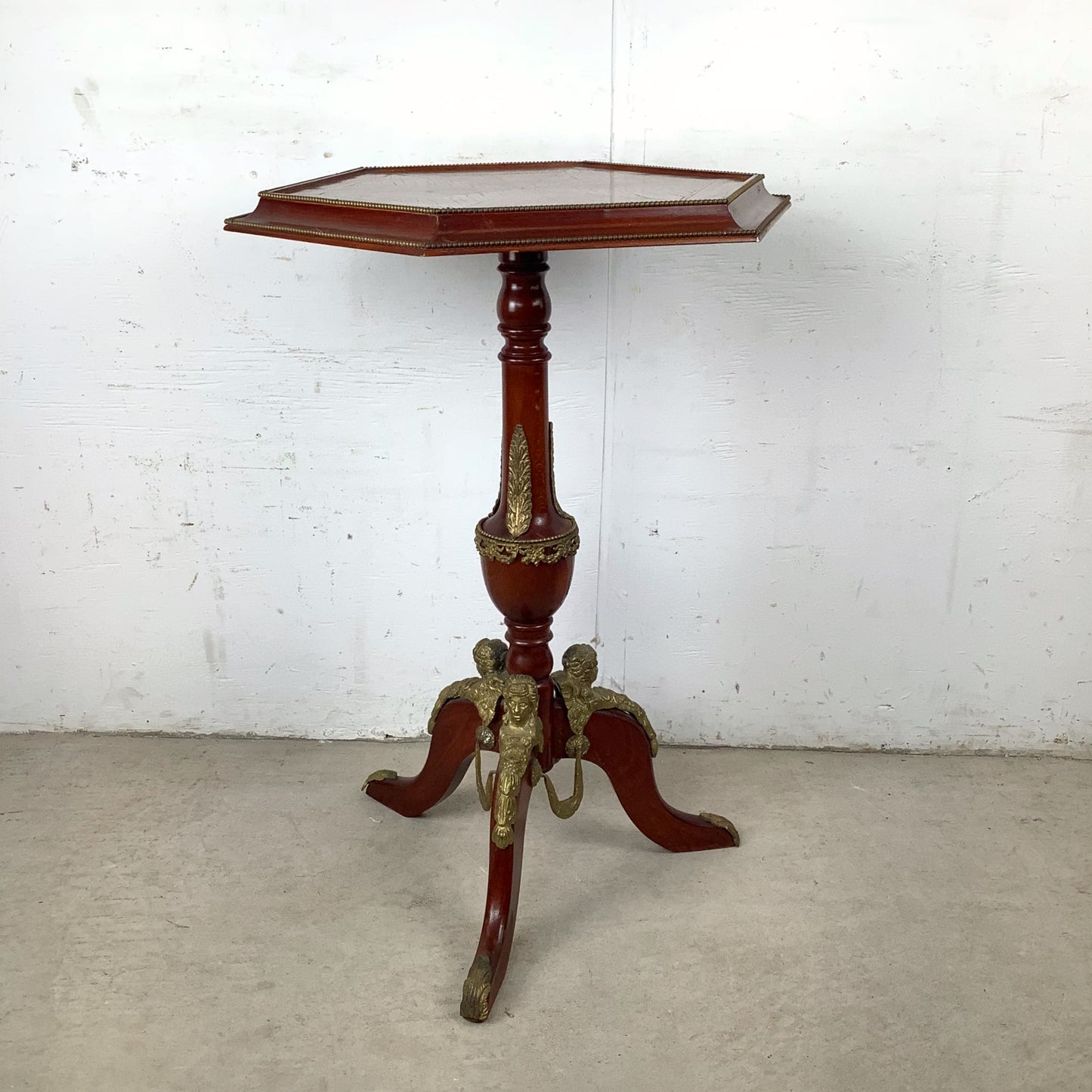 Ornate Pedestal Display Table with Brass Figural Accents