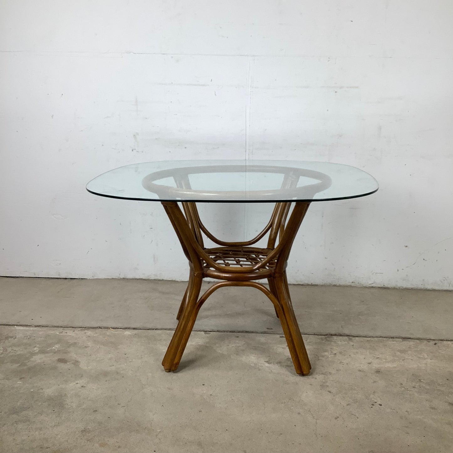 Vintage Rattan Dining Table | Sculptural Swept-Leg Base | Woven Lower Shelf | Oval Glass Top | c. 1970s–1980s