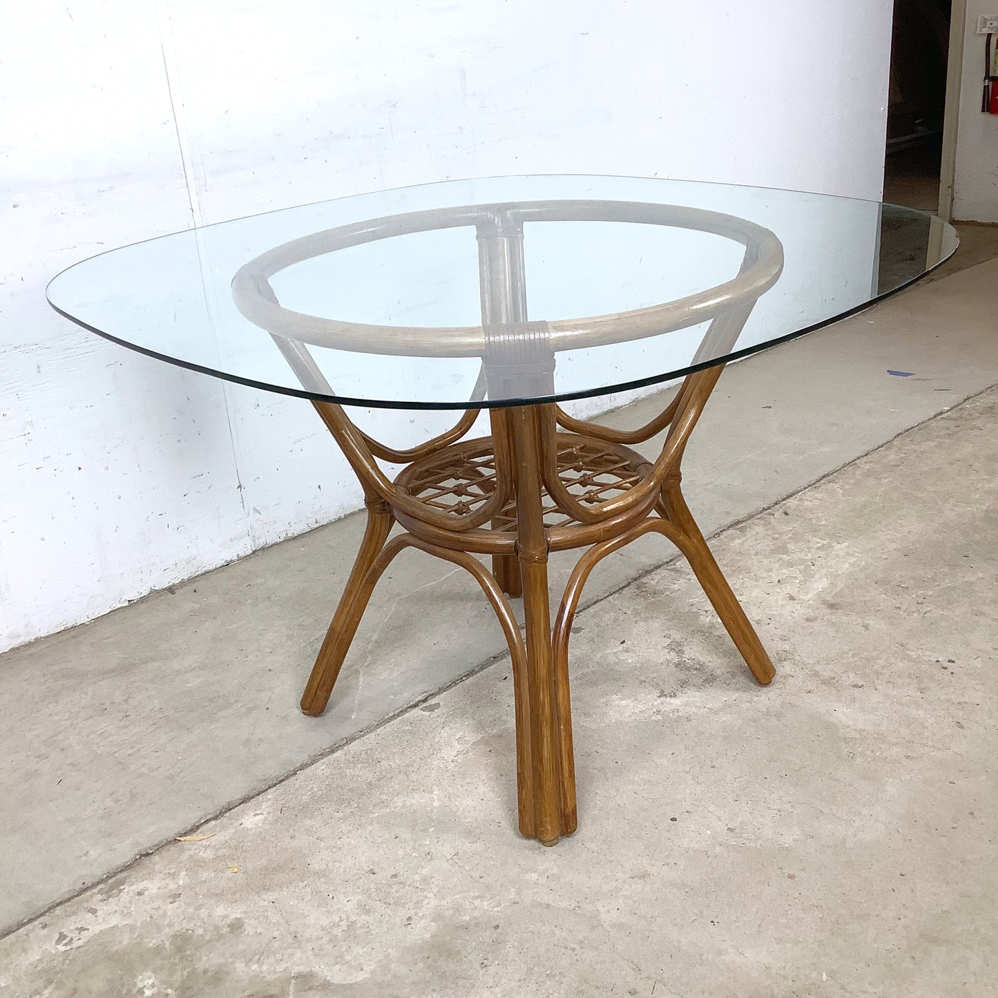 Vintage Rattan Dining Table | Sculptural Swept-Leg Base | Woven Lower Shelf | Oval Glass Top | c. 1970s–1980s