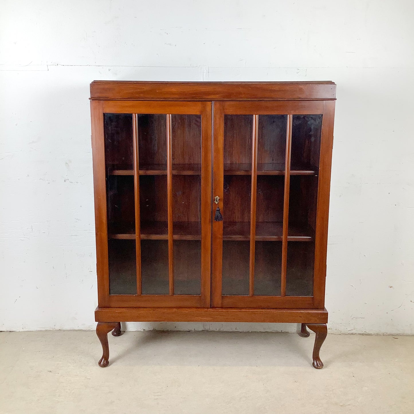 Classic Glass-Front Bookcase with Paneled Doors and Sculpted Legs