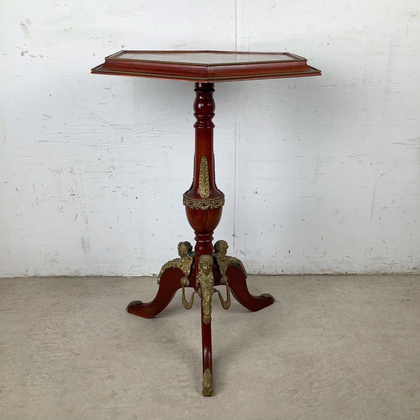 Ornate Pedestal Display Table with Brass Figural Accents