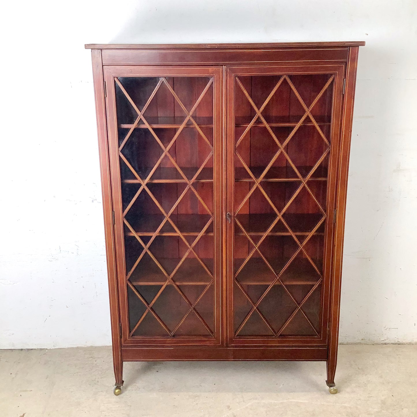 Edwardian Revival Mahogany Diamond Lattice Glazed Bookcase | Satinwood Inlay | Brass Casters