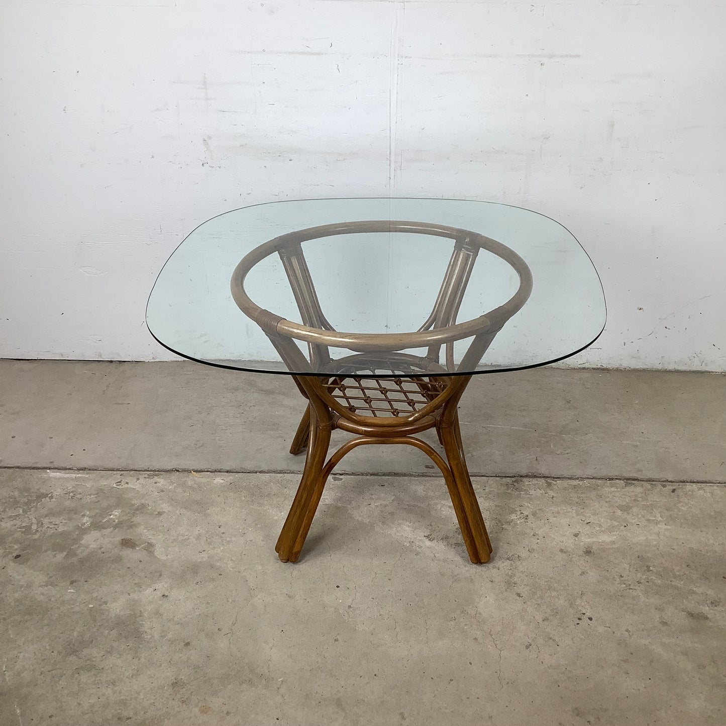 Vintage Rattan Dining Table | Sculptural Swept-Leg Base | Woven Lower Shelf | Oval Glass Top | c. 1970s–1980s