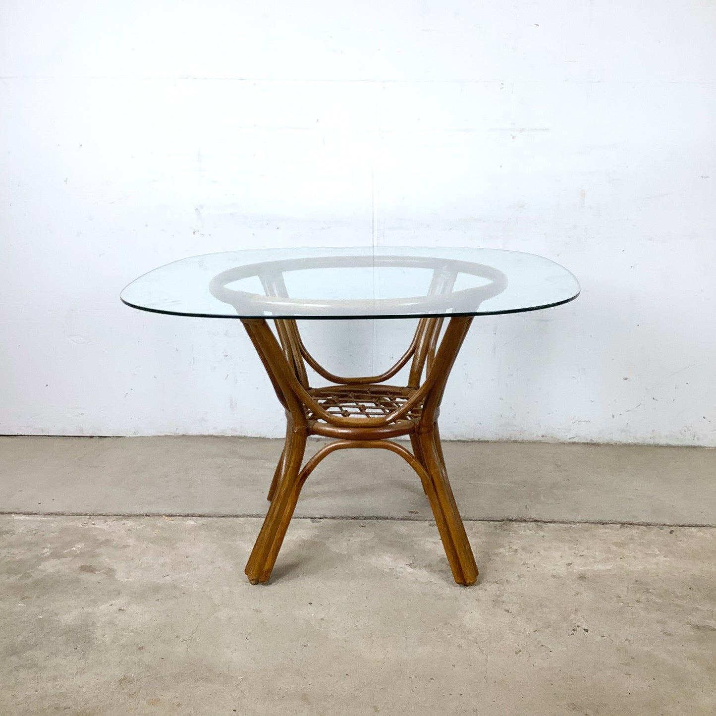Vintage Rattan Dining Table | Sculptural Swept-Leg Base | Woven Lower Shelf | Oval Glass Top | c. 1970s–1980s